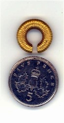 A Bronze Age Penannular Loop. A treasure find made during the Edgehill battlefield survey. The 5p piece is provided to show the tiny size of the object.