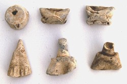 Lead powder box caps and priming flask tops from the Civil War siege site at Basing Castle, Hampshire