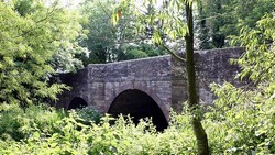 The bridge over the river Lugg viewed from the south east. An inscription records that it was constructed in 1771 and widened in 1938.