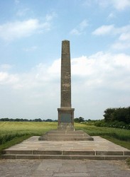 Looking north to the battlefield monument, with the former moor in the distance beyond.