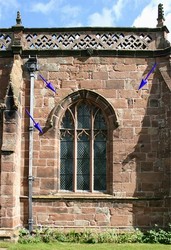 The south wall of the south aisle of Acton church with arrows indicating the most obvious shot impact scars, which probably relate to the parliamentarian attack on the baggage train.