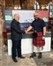 Dr Andrew Abram hands over the information board to Rev Martin Fuller
