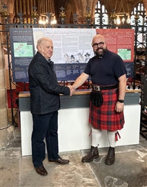 Dr Andrew Abram hands over the information board to Rev Martin Fuller