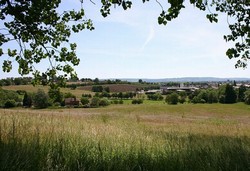 Looking south east from the edge of Abbey Manor House park to Greenhill, viewed across the valley running down from Battle Well, with the tower of the Abbey church in the distance to the right.